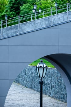 Street vintage lantern on the background of the arch of the bridge.