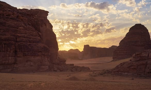 Morning sun shines over rocky desert formations, typical landscape in Al Ula, Saudi Arabia.