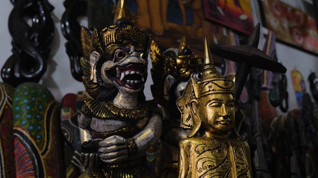 Hindu and Buddhist wooden carving. souvenir shop selling souvenirs and handicrafts of Bali at famous Ubud Market, Indonesia