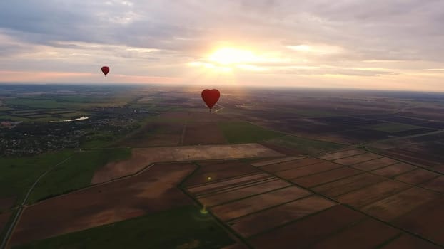 Aerial view Hot air balloons in the sky over a field in the countryside in the beautiful sky and sunset. Aerostat fly in the countryside.