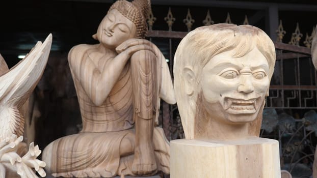 Hindu and Buddhist wooden carving. souvenir shop selling souvenirs and handicrafts of Bali at famous Ubud Market, Indonesia