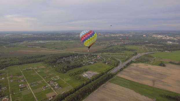 Hot air balloon in the sky over a field in the countryside. Aerostat fly in the countryside.
