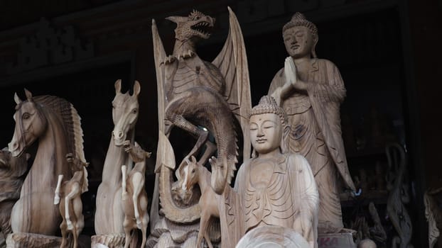 Hindu and Buddhist wooden carving. souvenir shop selling souvenirs and handicrafts of Bali at famous Ubud Market, Indonesia