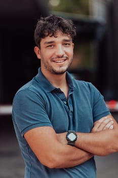 Portrait of a young successful entrepreneur in front of the company. High quality photo