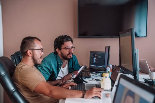 Programmers engrossed in deep collaboration, diligently working together to solve complex problems and develop innovative mobile applications with seamless functionality