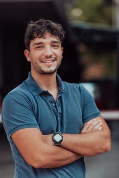 Portrait of a young successful entrepreneur in front of the company. High quality photo