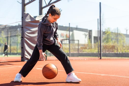 beautiful girl shooting basket and playing basketball.