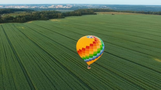 Aerial view Hot air balloon in the sky over a field in the countryside in the beautiful sky and sunset. Balloon silhouette with sunrise, Aerostat fly in the countryside.