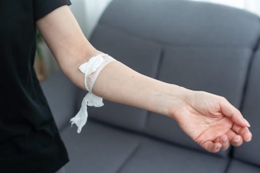 Adhesive plaster on the woman hand. Hand after donating blood.