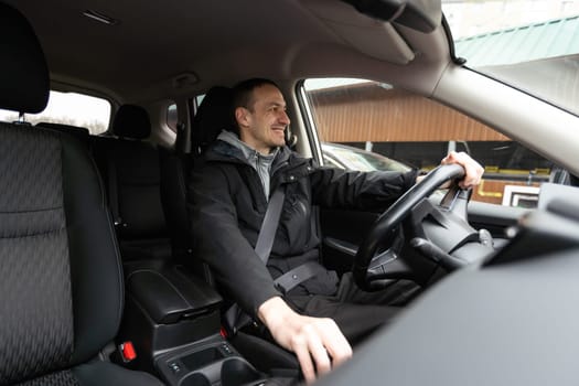 Attractive elegant happy man in good car. High quality photo