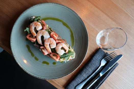 Savory Shrimp Bruschetta on Blue Plate, Resting on Wooden Table