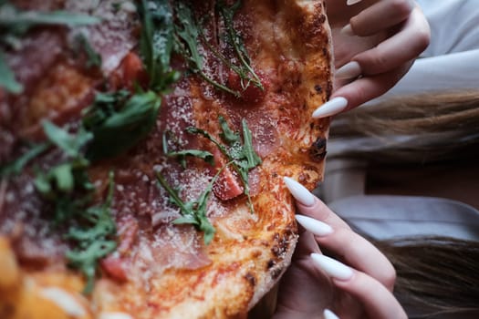 Delicious Prosciutto Pizza with Tomatoes, Cheese, and Arugula on Wooden Table