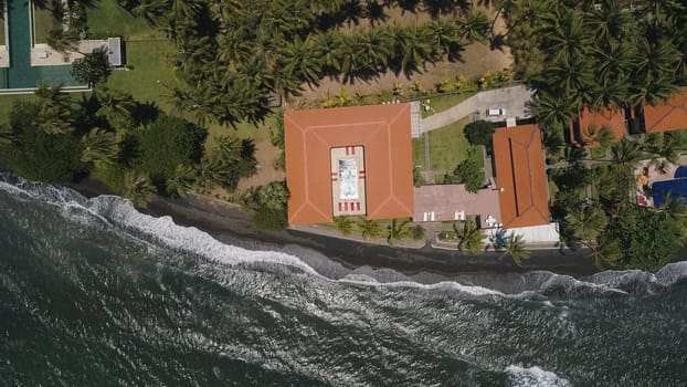 aerial view luxury hotel with swimming pool, sun beds, palm trees by sea. tropical resort with pool. Travel concept.