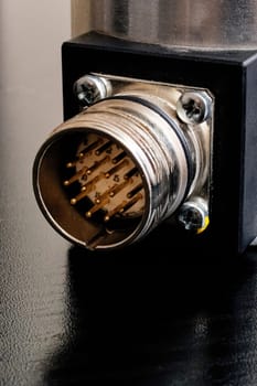 Metal encoder on a black wooden table close up