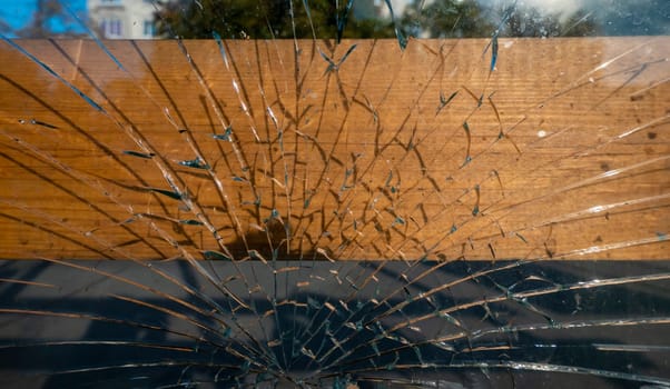 Broken glass at a street bus stop . High quality photo