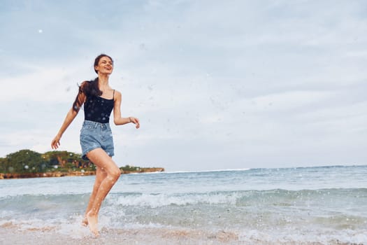 woman smiling hair sunset bikini female space smile lifestyle copy long flight summer shore sand sea young running body beach travel person walking