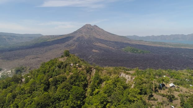 Aerial view volcano batur covered with vegetation mountain landscape with volcano sky and clouds Bali, Indonesia. Travel concept.