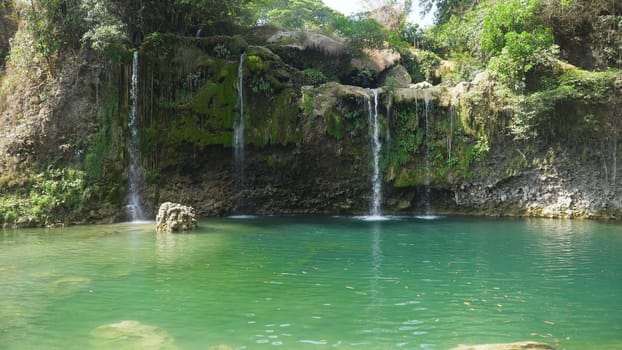 Waterfall in green rainforest. Bolinao waterfall in the mountain jungle. Philippines, Luzon. Travel concept.