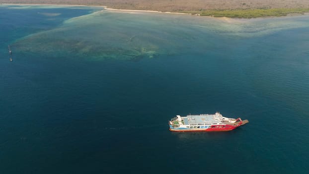 public ferry ships carrying passengers from Gilimanuk harbour ferry port in Bali Island to Ketapang harbour East Java, Indonesia
