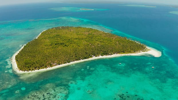 Sandy beach and tropical island by atoll with coral reef, top view. Patongong Island with sandy beach. Summer and travel vacation concept.