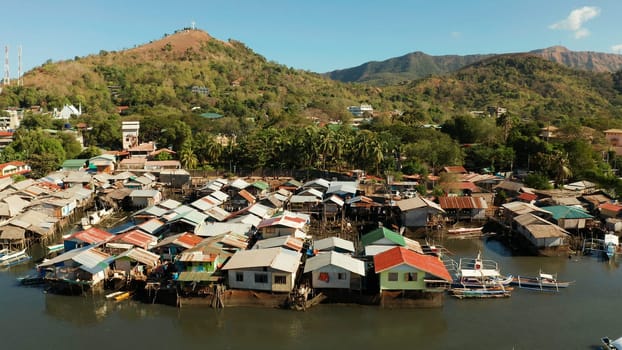 Coron city with slums and poor district. Old wooden house standing on the sea in the fishing village. Houses of local poor people.Busuanga, Coron, Philippines. houses community standing in water in fishing village.