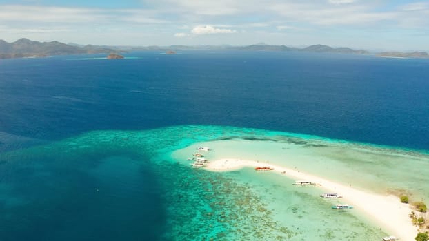 aerial seascape tropical island with sand bar, turquoise water and coral reef. Ditaytayan, Palawan, Philippines. tourist boats on tropical beach. Travel tropical concept. Palawan, Philippines