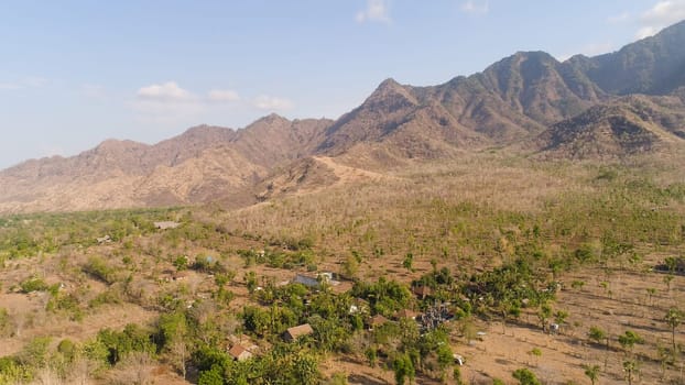 aerial view agricultural land and mountains in countryside. mountain range with high cliffs mountain slopes covered with vegetation bali, indonesia