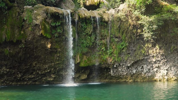 Waterfall in green rainforest. Bolinao waterfall in the mountain jungle. Philippines, Luzon. Travel concept.