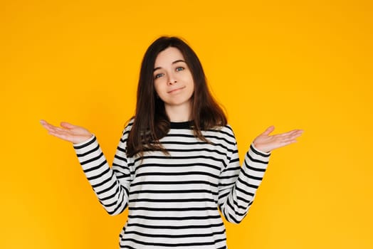 Visual of Assertive Woman: Attractive Lady Displaying 'No Answer' Gesture with Both Hands - Nonverbal Communication Concept Isolated on Bright Yellow Background.