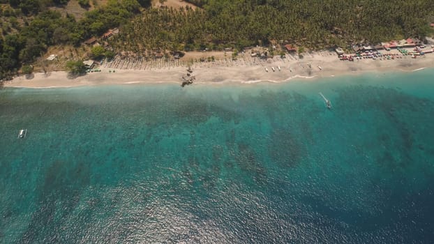 sandy beach with palm trees in tropical resort. aerial seascape sand beach with turquoise water. Seascape, ocean and beautiful beach.Travel concept. Indonesia, Bali