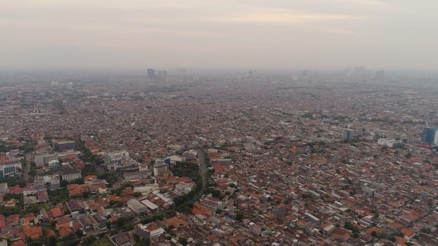 Aerial cityscape modern city Surabaya with skyscrapers, buildings and houses. sunset in city skyline with skyscrapers and business centers Surabaya capital city east java, indonesia