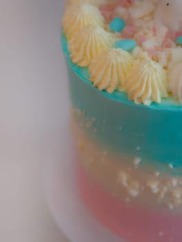 preparing frosted pink blue cup cake with meringue, sweet sprinkles and unicorn topping