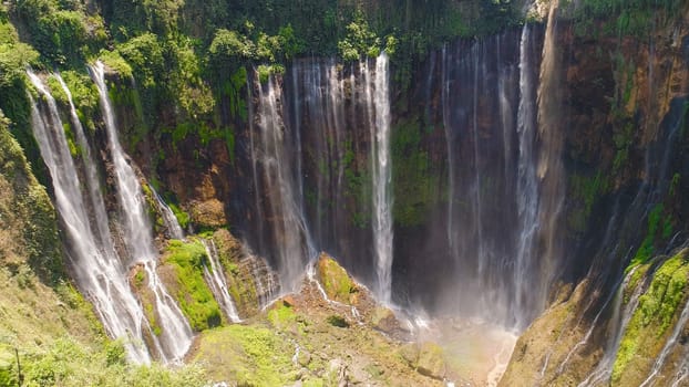 aerial view waterfall coban sewu in Java, indonesia. waterfall in tropical forest by drone Tumpak Sewu