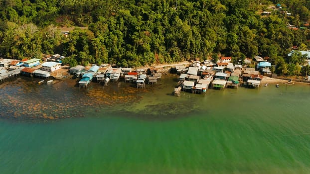 Village of stilt houses built over the sea, top view. City and port on Balabac Island, Palawan, Philippines.