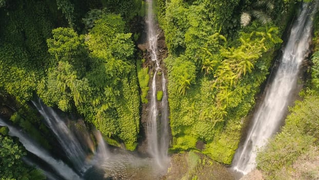 waterfall in green rainforest. Aerial view triple tropical waterfall Sekumpul in mountain jungle. Bali,Indonesia. Travel concept.