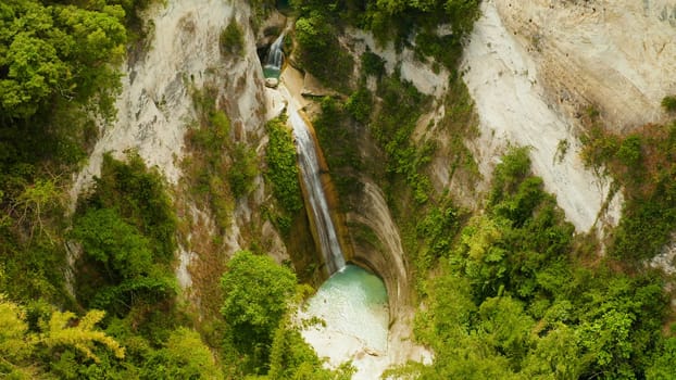 Beautiful waterfall in green forest, top view. Tropical Dao Falls in mountain jungle, Philippines, Cebu. Waterfall in the tropical forest.