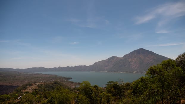 mountain landscape crater lake batur mountains with trees against blue sky Bali, Indonesia. Travel concept.