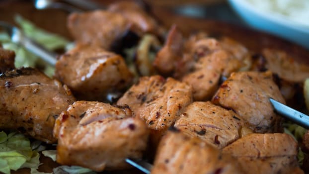 Barbecue skewers with juicy meat onplate. Shish kebab from pork