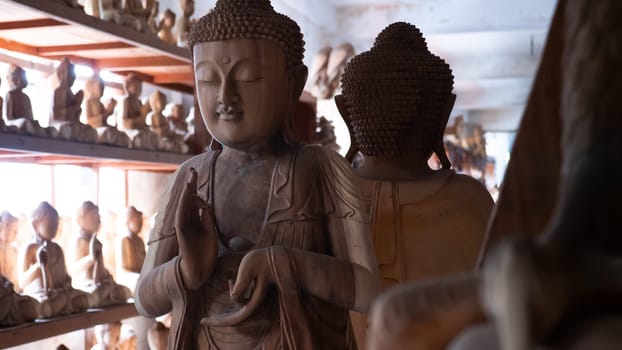 Hindu and Buddhist wooden carving. souvenir shop selling souvenirs and handicrafts of Bali at famous Ubud Market, Indonesia
