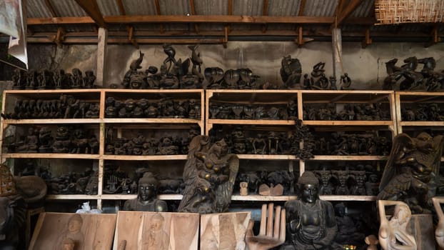 Hindu and Buddhist wooden carving. souvenir shop selling souvenirs and handicrafts of Bali at famous Ubud Market, Indonesia