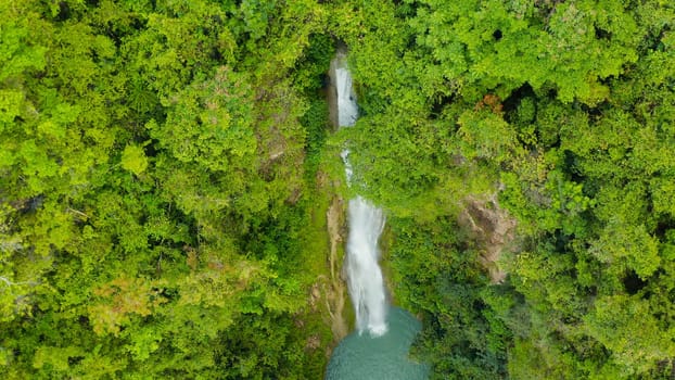 Aerial view of Mantayupan waterfalls in a mountain gorge in the tropical jungle, Philippines, Cebu. Waterfall in the tropical forest.