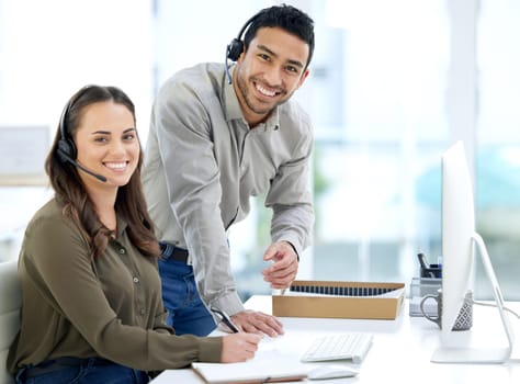 Call center, man coaching woman and smile in portrait, office and writing notes for learning at telemarketing job. Crm, teaching and notebook for customer service, consulting and tech support with pc.