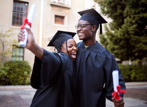 Black students, hug and celebration for graduation, education and achievement on university, campus and success. African American woman, man or academics with smile, embrace or joy for college degree.