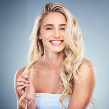 Happiness, hair and beauty of a woman in studio for luxury hair care with shampoo for health, wellness and growth or shine. Portrait, face and smile of model in studio for self care cosmetics.
