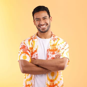Shirt, portrait and man with arms crossed in studio isolated on a yellow background. Fashion, aesthetic and happy, proud and confident man from Singapore in stylish, cool or designer tie dye clothing.