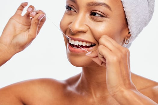 Face, hands and black woman flossing teeth, dental health and hygiene isolated on white background. Oral care product, floss and mouth cleaning for fresh breath in studio with happy model.