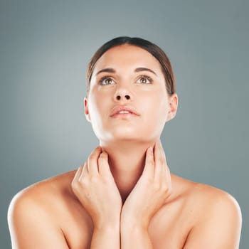 Woman, beauty and hands on neck in skincare satisfaction for cosmetic treatment against grey studio background. Face of beautiful female touching soft, smooth or perfect skin for healthy wellness.