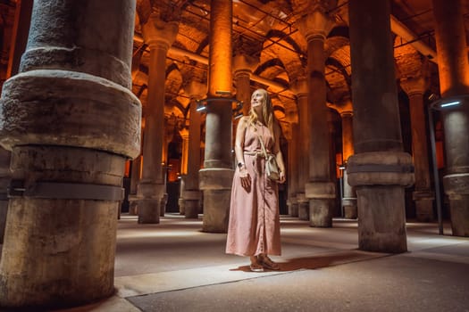 Woman tourist enjoying Beautiful cistern in Istanbul. Cistern - underground water reservoir build in 6th century, Istanbul, Turkey, Turkiye.