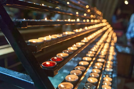 Many candles burn in a temple in Vienna. High quality 4k footage.