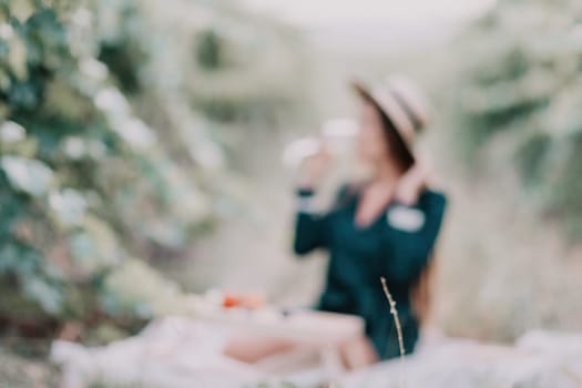 Picnic and wine tasting at sunset in the hills of Italy, Tuscany. Vineyards and open nature in the summer. Romantic dinner, fruit and wine.